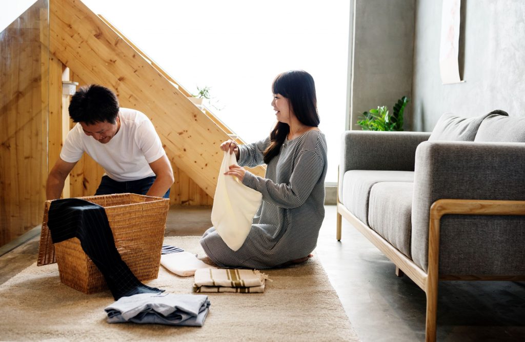Couple folding laundry together